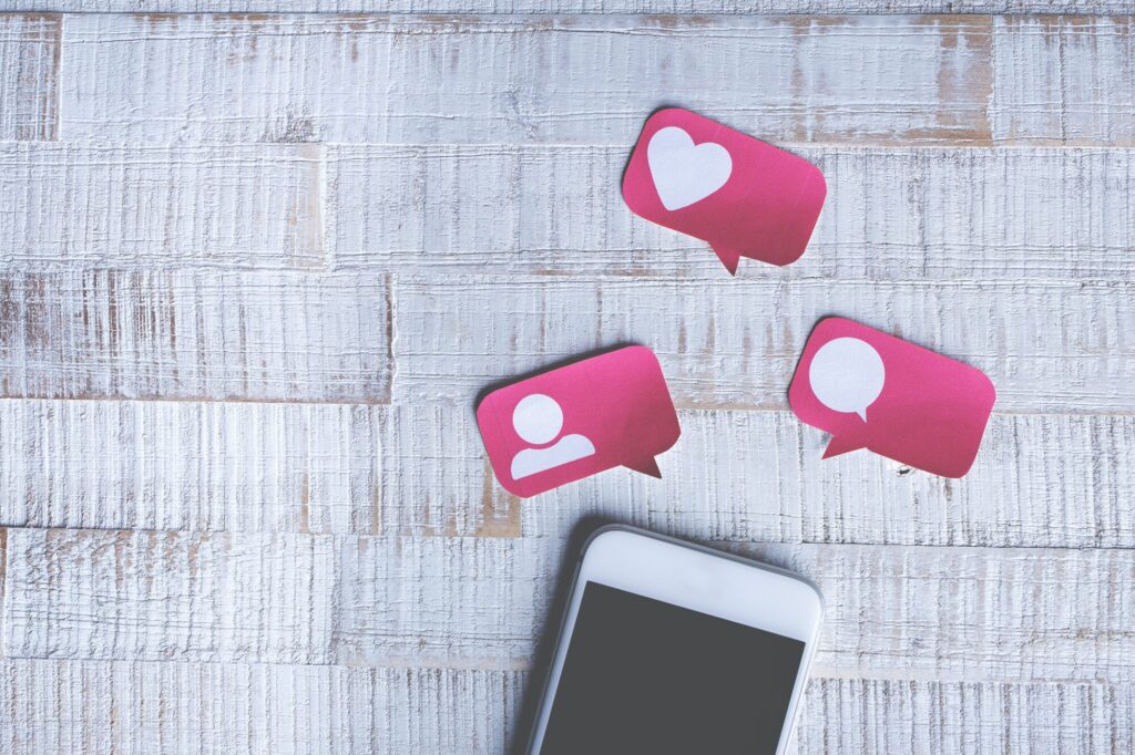 An image of a hand holding a smartphone using Twitter