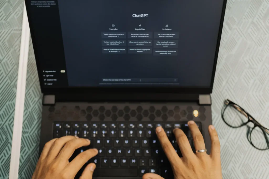 A person using a laptop on an AI software website
